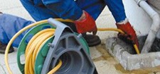 Plumber in Edinburgh cleaning a drain